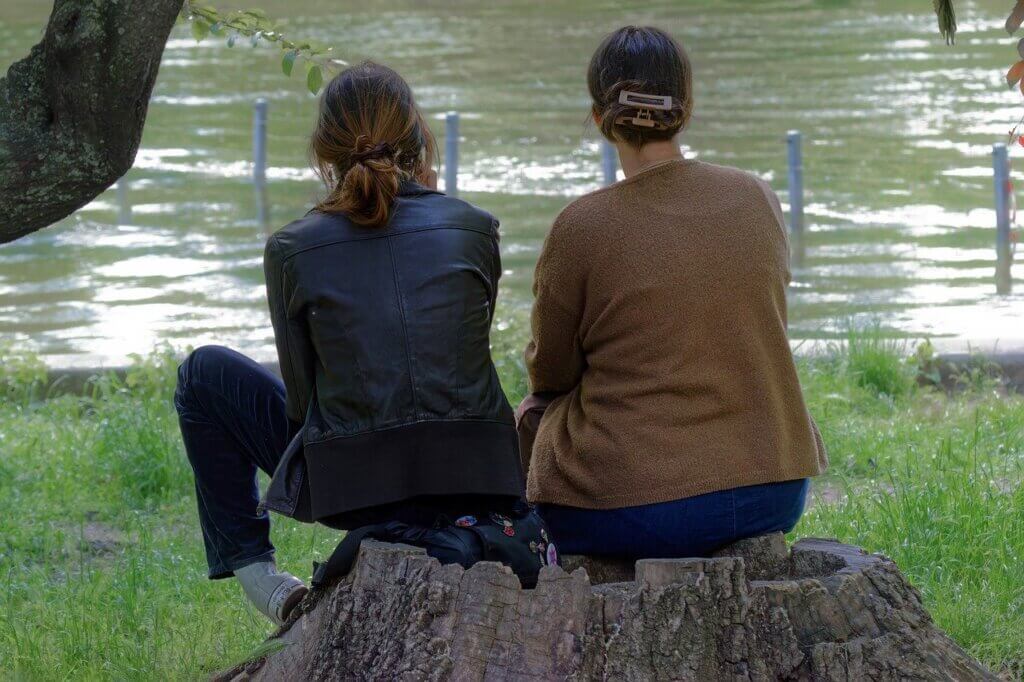 girls, together, sitting, tree trunk, lakeshore, looking, lake, nature, park, relaxation, recreation, lifestyle, people